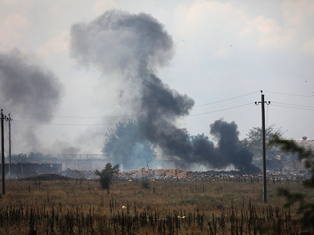 Smoke rises over the site of explosion at an ammunition storage of Russian army near the v