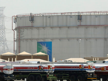 FILE - Fuel trucks line up in front of storage tanks at the North Jiddah bulk plant, an Aramco oil facility, in Jiddah, Saudi Arabia, March 21, 2021. Saudi Aramco announced a $2.65 billion agreement on Monday, Aug. 1, 2022, to acquire Valvoline's global products business, which includes motor oils, …