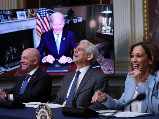 WASHINGTON, DC - AUGUST 03: (L-R) Homeland Security Secretary Alejandro Mayorkas, Attorney General Merrick Garland, and U.S. Vice President Kamala Harris laugh after U.S. President Joe Biden, appearing via teleconference, noted that Harris was speaking while "muted" during a meeting of the Task Force on Reproductive Healthcare Access during an …