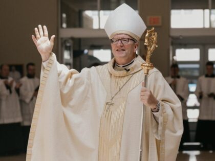 Bishop Robert E. Barron waves following his installation as the ninth Bishop of the Diocese of Winona-Rochester on July 29 at the Co-Cathedral of St. John the Evangelist in Rochester. (Diocese of Winona-Rochester)