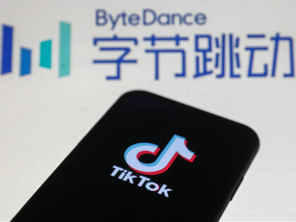 TikTok logo is seen displayed on a phone screen with ByteDance logo in the background in t