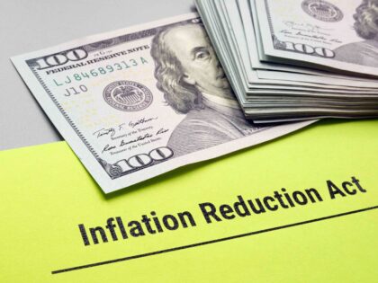 The Inflation Reduction Act of 2022 papers and cash on it. (Getty)