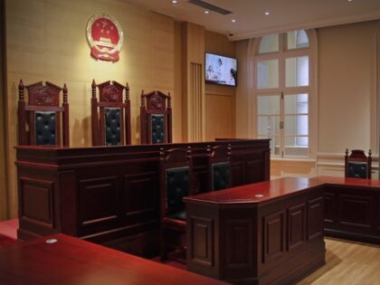 A security guard walks into a mocked courtroom on display at the China Court Museum in Beijing, Tuesday, April 11, 2017. China's use of the death penalty remains shrouded in secrecy and still outpaces the rest of the world combined, even after the nation's execution rate fell sharply over the …
