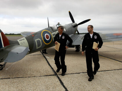 LONDON, ENGLAND - AUGUST 20: (EDITORS NOTE: A Graduated filter was used in the creation of this image) Squadron Leader Al Pinner (left) and Squadron Leader Duncan Mason (right) of the RAF walk past a Spitfire Mk Vb from the Battle of Britain Memorial Flight at Biggin Hill Airfield on …