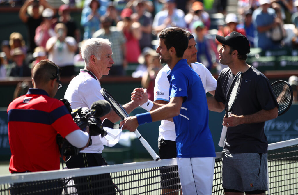 L-R Novak Djokovic and Pete Sampras shakes hands at the net after their exhibition doubles match against Tommy Haas and John McEnroe on day thirteen of the BNP Paribas Open at the Indian Wells Tennis Garden on March 16, 2019 in Indian Wells, California. (Photo by Clive Brunskill/Getty Images)