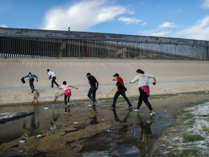 Migrants cross the border between the U.S. and Mexico at the Rio Grande river, as they enter El Paso, Texas, on May 19, 2019 as taken from Ciudad Juarez, Mexico. The location is in an area where migrants frequently turn themselves in and ask for asylum in the U.S. after …