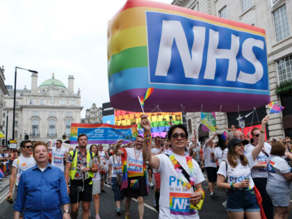 REGENTS STREET SAINT JAME'S, LONDON, GREATER LONDON, UNITED KINGDOM - 2019/07/06: NHS Staff march with a huge NHS rainbow inflatable during the Pride parade. Thousands of revellers filled Londons streets with colour to celebrate Pride in the capital city. 2019 marked the 50th anniversary of the Stonewall riots in New …