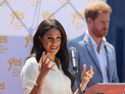 JOHANNESBURG, SOUTH AFRICA - OCTOBER 02: Meghan, Duchess of Sussex speaks as Prince Harry, Duke of Sussex looks on during a visit a township to learn about Youth Employment Services on October 02, 2019 in Johannesburg, South Africa. (Photo by Chris Jackson/Getty Images)