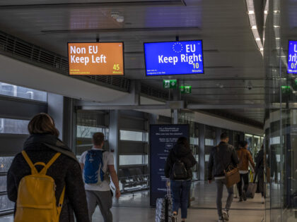 Digital signs direct arriving passengers to non-European Union (EU), left, and EU passport clearance, right, at Dublin Airport in Dublin, Ireland, on Saturday, Dec. 28, 2019. Ireland issued a record number of passports in 2019 as applications from its citizens in the U.K. surged amid Brexit uncertainty. Photographer: Hollie Adams/Bloomberg …