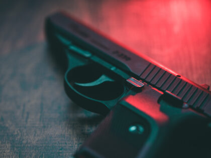 Semi automatic hand gun and red light.