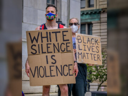 NEW YORK, UNITED STATES - 2020/06/27: Participant holding a White Silence Is Violence sign at the protest. CUNY students, faculty, and community members, joined by elected officials participated on a march from Brooklyn Borough Hall to the Defund The Police Occupation at City Hall demanding the city administration to redirect …