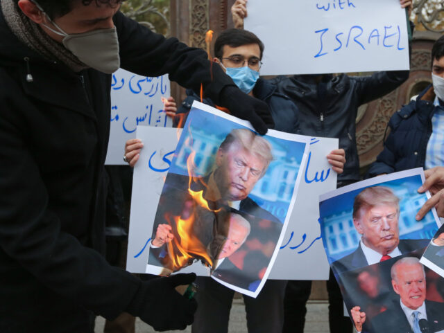 Students of Iran's Basij paramilitary force burn posters depicting US President Donald Tru