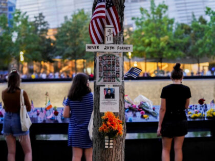 People mourn for the victims at the National September 11 Memorial & Museum in New York, the United States, Sept. 11, 2021. (Photo by Wang Ying/Xinhua via Getty Images)