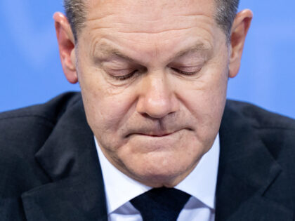 German Chancellor Olaf Scholz looks down as he addresses a press conference following consultations with the premiers of the German federal states on measures to curb the coronavirus (Covid-19) pandemic, at the Chancellery in Berlin on December 21, 2021. - Germany's leaders on December 21 limited private New Year's parties …