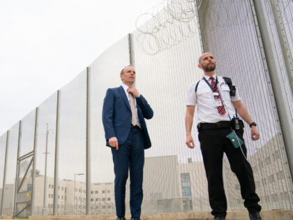 Deputy Prime Minister and Justice Secretary Dominic Raab with a prison officer at the opening of category C prison HMP Five Wells in Wellingborough. Picture date: Thursday March 3, 2022. (Photo by Joe Giddens/PA Images via Getty Images)