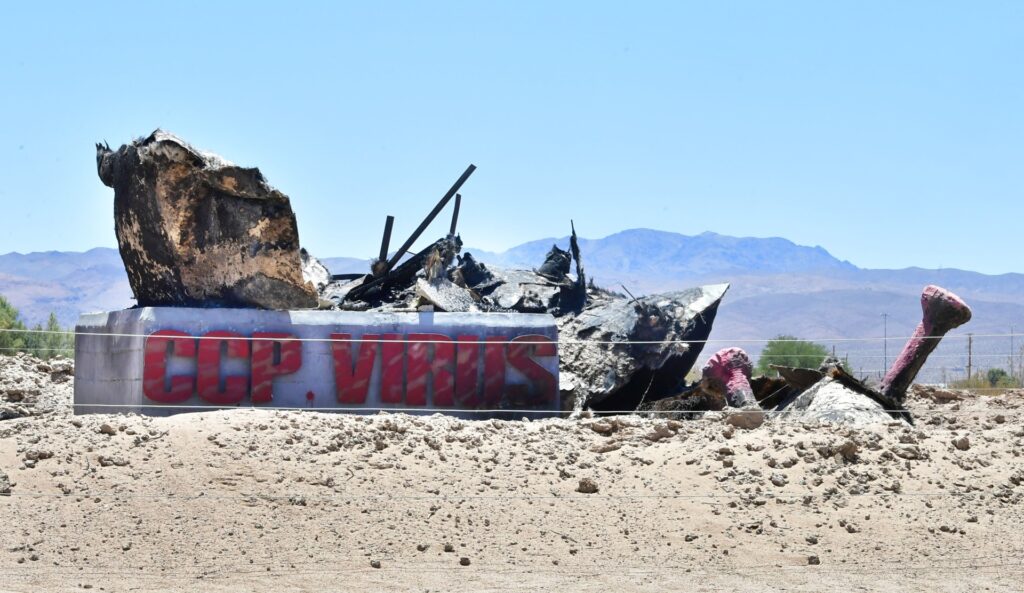 The rubble from the destroyed "CCP Virus" sculpture by artist Chen Weiming is seen at Liberty Sculpture Park in Yermo, California on June 1, 2022. - A new sculpture "CCP Virus II", made of steel and weighing 10 tons, was displayed today before the weekend commemoration marking the anniversary of June 4, 1989 in Tiananmen. Chen Weiming unveiled his original sculpture "CCP Virus" here last June, but it was destroyed a month later, burned to the ground. In March 2022, federal prosecutors charged five men acting on behalf of the Chinese government with destroying the original sculpture. - RESTRICTED TO EDITORIAL USE - MANDATORY MENTION OF THE ARTIST UPON PUBLICATION - TO ILLUSTRATE THE EVENT AS SPECIFIED IN THE CAPTION (Photo by Frederic J. BROWN / AFP) / RESTRICTED TO EDITORIAL USE - MANDATORY MENTION OF THE ARTIST UPON PUBLICATION - TO ILLUSTRATE THE EVENT AS SPECIFIED IN THE CAPTION / RESTRICTED TO EDITORIAL USE - MANDATORY MENTION OF THE ARTIST UPON PUBLICATION - TO ILLUSTRATE THE EVENT AS SPECIFIED IN THE CAPTION (Photo by FREDERIC J. BROWN/AFP via Getty Images)
