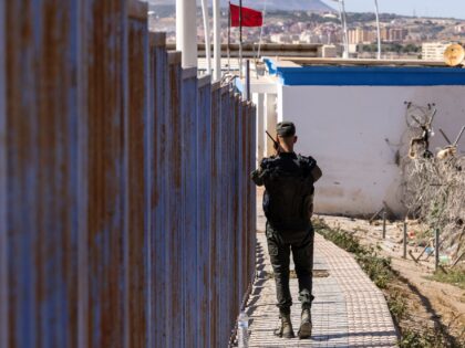 A Moroccan security forces guard patrols the border fence separating Morocco and Spain's North African enclave of Melilla, on June 26, 2022 near Nador, two days after a massive attempt by migrants to storm the barrier between Morocco and Melilla resulted in "unprecedented violence" that killed at least 23 sub-Saharan …