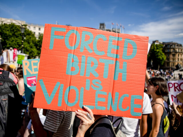 LONDON, UNITED KINGDOM - 2022/07/09: Protesters hold placards expressing their opinion dur