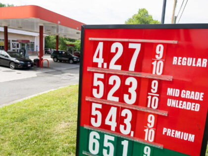 A sign displays gas prices at a gas station in Falls Church, Virginia, July 19, 2022. - US gasoline prices have fallen from historic highs earlier in the summer, a retreat highlighted by a politically beset White House as a sign of moderating inflation. President Joe Biden took to Twitter …
