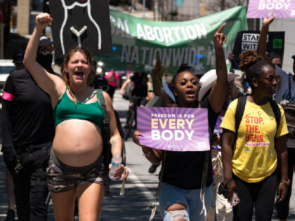 ATLANTA, GA - JULY 23: Mia Knighton (Left) marchs along side other protestors in Downtown Atlanta, in opposition to Georgia's new abortion law on July 23, 2022 in Atlanta, Georgia. A federal appeals court has decided to allow a Georgia law that bans abortion after six weeks of pregnancy to …