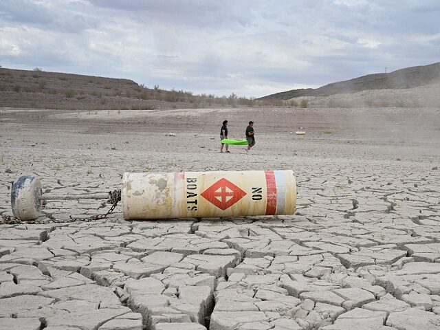 TOPSHOT - A buoy that reads 'No Boats' lays on cracked dry earth where water onc