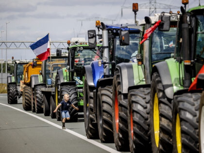 Farmers block the A35 motorway with tractors as they protest against the government's nitrogen reforms, near Almelo, on July 28, 2022. - Farmers are protesting the government's far-reaching plans to cut nitrogen emissions, which could see livestock reduced by almost a third. The Netherlands, the world's second largest agricultural exporter, …