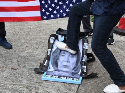 A pro-Beijing protester stamps on an image depicting the US House Speaker Nancy Pelosi at