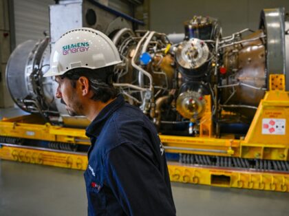 An employee of Siemens Energy stands on August 3, 2022 in front of a turbine of the Nord S
