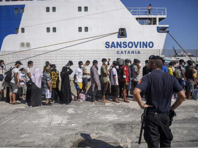 LAMPEDUSA, ITALY - 04: Migrants wait to board a commercial ship before being transferred f