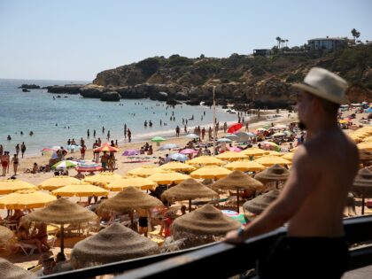 Beachgoers sunbathe and swim at Oura beach in Albufeira, Algarve region, Portugal on Aug. 6, 2022. Tourism is rebounding quickly in Portugal. (Photo by Pedro Fiuza/Xinhua via Getty Images)