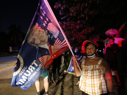 PALM BEACH, FL - AUGUST 08: Supporters of former President Donald Trump hold flags in front of his home at Mar-A-Lago on August 8, 2022 in Palm Beach, Florida. The FBI raided the home to retrieve classified White House documents. (Photo by Eva Marie Uzcategui/Getty Images)