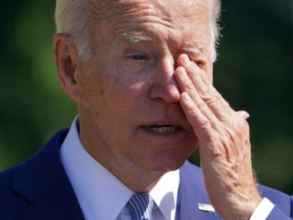 US President Joe Biden wipes his eyes while speaking during a signing ceremony for the CHI