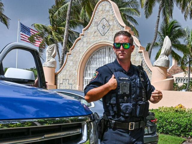 Local law enforcement officers are seen in front of the home of former President Donald Trump at Mar-A-Lago in Palm Beach, Florida on August 9, 2022. - Former US president Donald Trump said August 8, 2022 that his Mar-A-Lago residence in Florida was being "raided" by FBI agents in what …