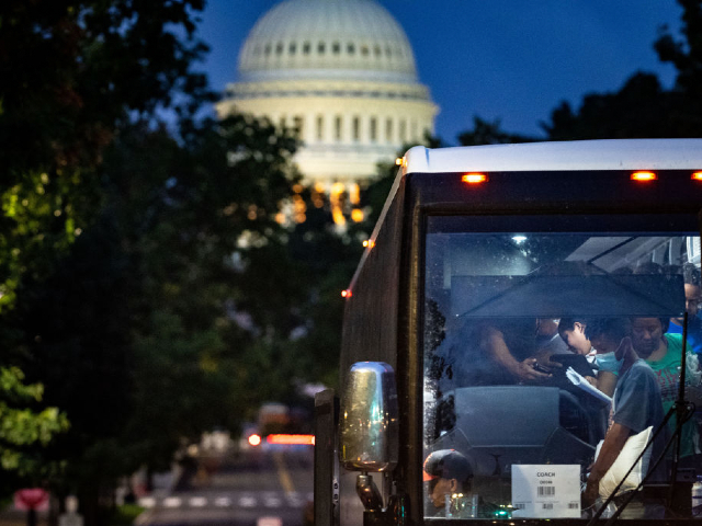 WASHINGTON, DC - AUGUST 11: Migrants disembark a bus from Texas within view of the U.S. Capitol on Thursday, Aug. 11, 2022 in Washington, DC. Since April, Texas Governor Greg Abbott has ordered over 150 buses to carry approximately 4,500 migrants from Texas to Washington, DC, to highlight criticisms of US President Bidens border policy. (Kent Nishimura / Los Angeles Times via Getty Images)