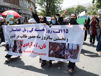 Afghan women hold placards as they march and shout slogans "Bread, work, freedom" during a womens' rights protest in Kabul on August 13, 2022. - Taliban fighters beat women protesters and fired into the air on Saturday as they violently dispersed a rare rally in the Afghan capital, days ahead …