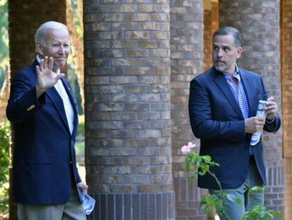 US President Joe Biden (L) waves alongside his son Hunter Biden after attending mass at Ho