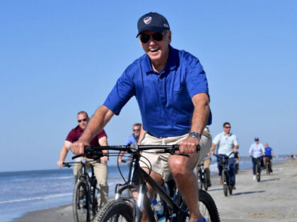 US President Joe Biden rides his bicycle along the beach while on vacation in Kiawah Island, South Carolina, on August 14, 2022. (Photo by Nicholas Kamm / AFP) (Photo by NICHOLAS KAMM/AFP via Getty Images)