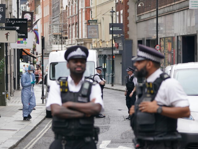 A forensic officer at the scene in Poland Street, central London, as a man has been stabbe