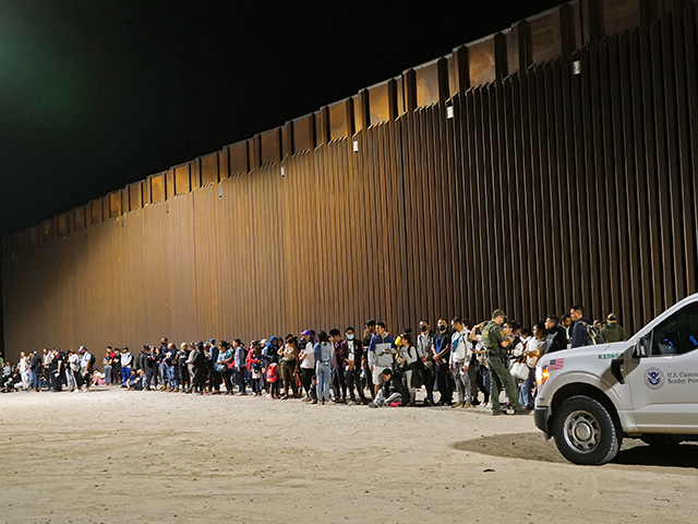 Migrants attempting to cross in to the U.S. from Mexico are detained by U.S. Customs and Border Protection at the border August 20, 2022 in San Luis, Arizona. (Photo by Nick Ut/Getty Images)