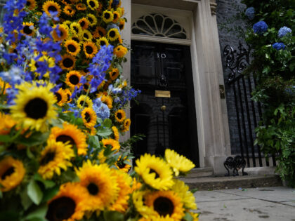 A floral arch of sunflowers, the national flower of Ukraine, at the door to 10 Downing Str