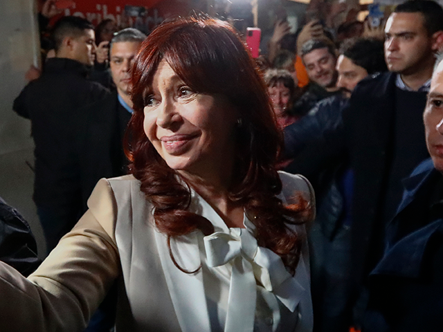 Vice President of Argentina Cristina Fernandez greets supporters as arriving at her apartm
