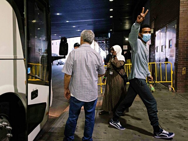 A migrant, who boarded a bus in Texas, gives a peace sign as they arrive at Port Authority Bus Terminal in New York City on August 25, 2022. - Since April, Texas Governor Greg Abbott has ordered buses to carry thousands of migrants from Texas to Washington, DC, and New …