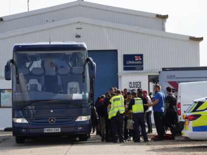 A group of people thought to be migrants boarding a coach after being brought in to Dungeness, Kent, onboard an RNLI Lifeboat following a small boat incident in the Channel. Picture date: Saturday August 27, 2022. (Photo by Gareth Fuller/PA Images via Getty Images)