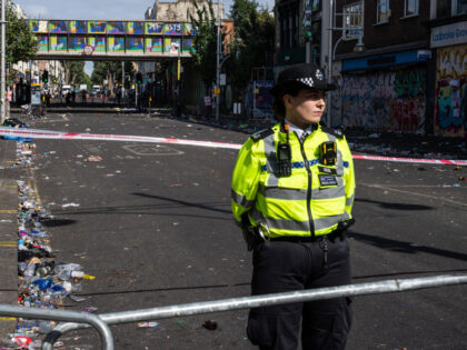 LONDON, ENGLAND - AUGUST 30: A police officer stands by the cordon at the scene of yesterd