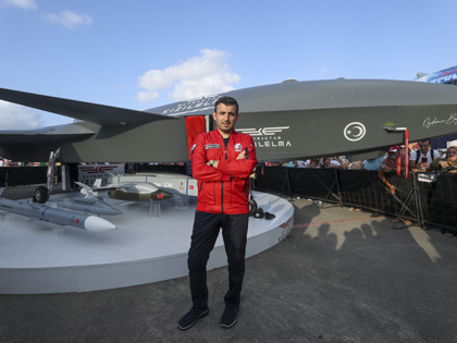 Chairman of the board of the Turkish Technology Team Selcuk Bayraktar poses for a photo with unmanned combat aircraft, Bayraktar Kizilelma during the TEKNOFEST Black Sea 2022, the Aviation, Space and Technology Festival in Samsun, Turkiye on August 30, 2022. (Photo by Mehmet Eser/Anadolu Agency via Getty Images)