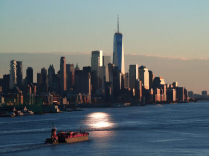 WEEHAWKEN, NJ - DECEMBER 7: A tugboat pushes a barge in the Hudson River as the sun sets on lower Manhattan and One World Trade Center on December 7, 2020 as seen from Weehawken, New Jersey. (Photo by Gary Hershorn/Getty Images)