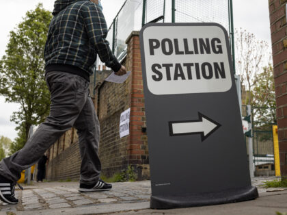 LONDON, ENGLAND - MAY 06: A man walks into a polling station at Walnut Tree Walk Primary S