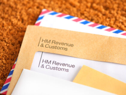 Tax letter in mail on doormat - stock photo