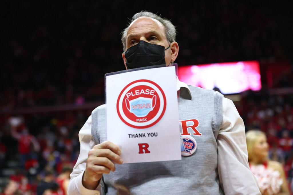 PISCATAWAY, NJ - DECEMBER 09: An usher holds a Please Wear a Mask sign during a timeout in a game between the Purdue Boilermakers and Rutgers Scarlet Knights at Jersey Mike's Arena on December 9, 2021 in Piscataway, New Jersey. Rutgers defeated Purdue 70-68. (Photo by Rich Schultz/Getty Images)