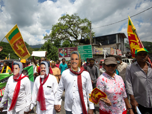 KANDY, SRI LANKA - APRIL 26: Demonstrators wear masks of Basil Rajapaksa, the Finance Minster of Sri Lanka, Mahinda Rajapaksa, the Prime Minister of Sri Lanka and Gotabaya Rajapaksa, the President of Sri Lanka as they demonstrate the country's ongoing economic and political crisis on April 26, 2022 in Penideniya, Sri Lanka. Demonstrations have continued across the tiny South Asian island nation for weeks, voicing anger against what they say is the government's mishandling of the economy that has caused millions of its people facing shortages of essentials, prolonged power cuts, soaring prices, a crippled health care system and an economic collapse of unprecedented levels that has led to record inflation adding to their hardships. (Photo by Abhishek Chinnappa/Getty Images)